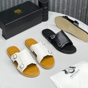High-quality image of luxury double strap sandals in black and white, featuring silver buckles and leather insoles, with a shoe box and dust bag.