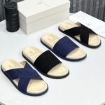 High-quality suede slides in navy and black, displayed with packaging and accessories, showcasing luxury footwear from Jsfootis.