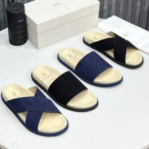 High-quality suede slides in navy and black, displayed with packaging and accessories, showcasing luxury footwear from Jsfootis.