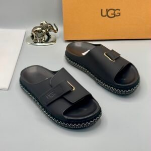 Grey UGG slide sandals with zigzag stitching and gold buckle on a white background, Jsfootis