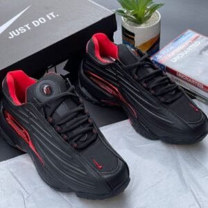 A pair of black and red Nike sport shoes with their box, perfect for those seeking a stylish and high-performance footwear option.
