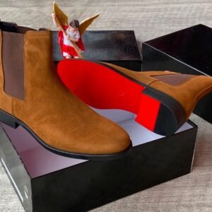 Brown suede Chelsea boots with elastic sides and black soles, presented in an open black box with red interior, Jsfootis