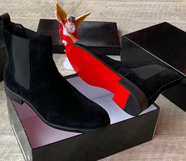 Brown suede Chelsea boots with elastic sides and black soles, presented in an open black box with red interior, Jsfootis