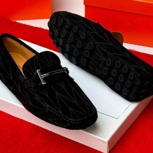 A pair of luxurious navy blue loafers with a sleek design and rubber studs on the sole, exuding sophistication and comfort, perfect for formal occasions.