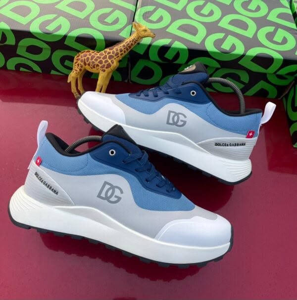 Experience luxury with Jsfootis, featuring sleek Dolce & Gabbana sneakers in blue and white, perfectly blending style and comfort for the discerning Nigerian fashionista.